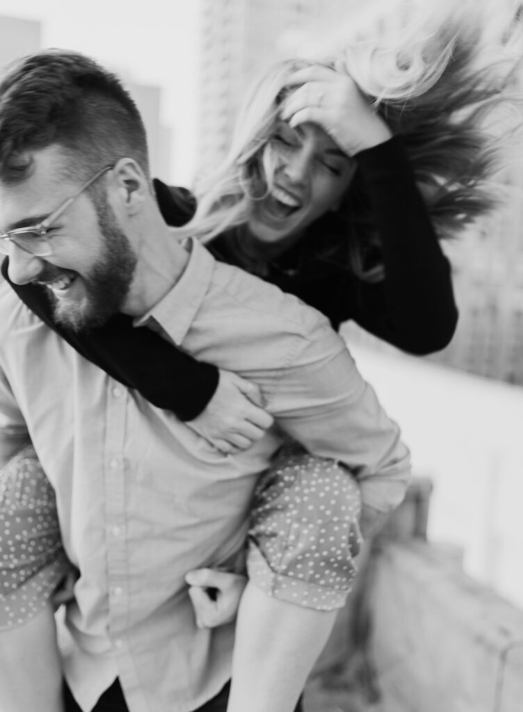 Tyler giving Ellie a piggyback ride during their engagement shoot.