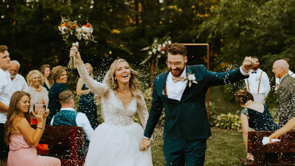 Ellie and Tyler Celebrating Down the aisle at their wedding.