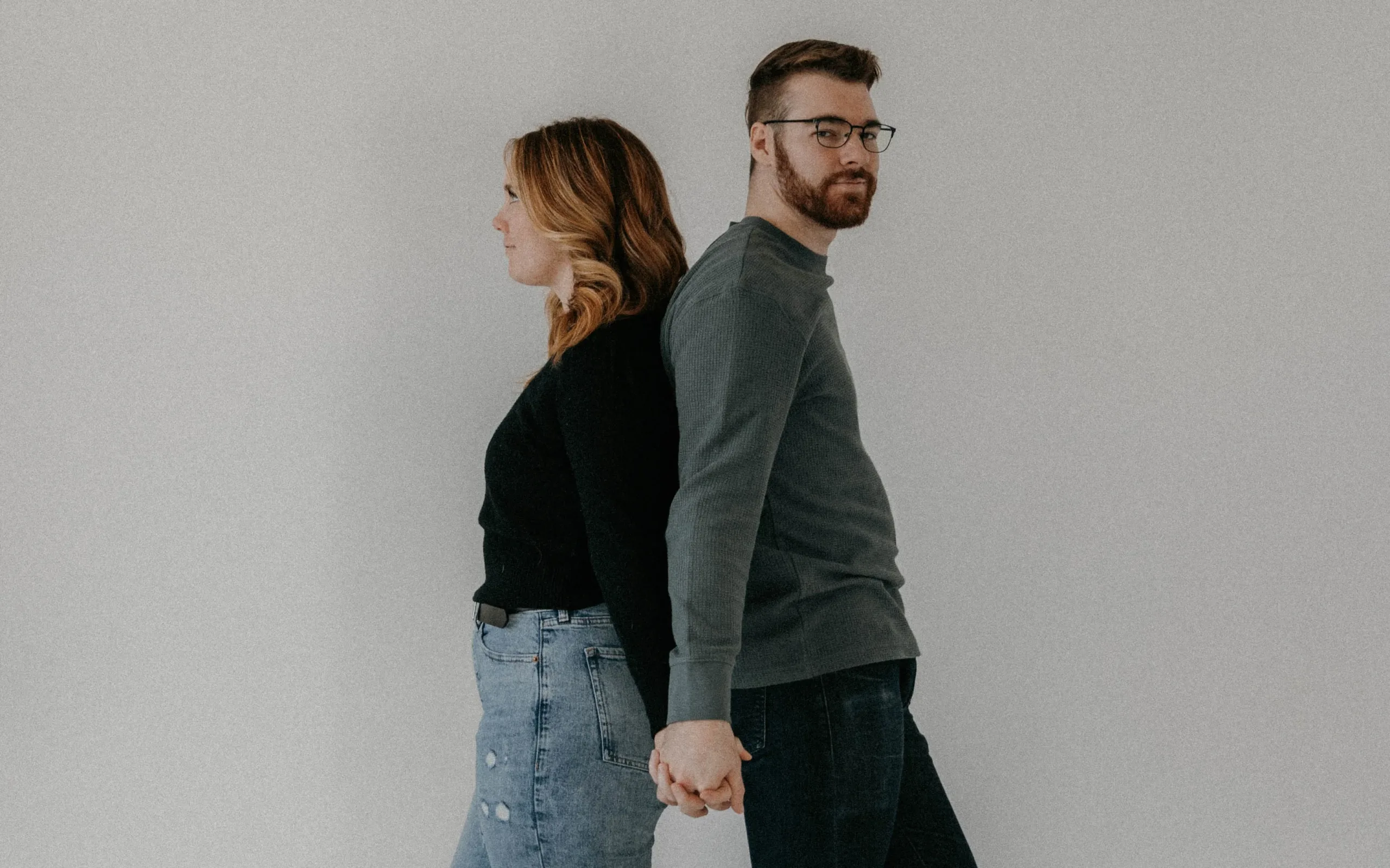 Tyler and Ellie posing in a studio. Contact Us!